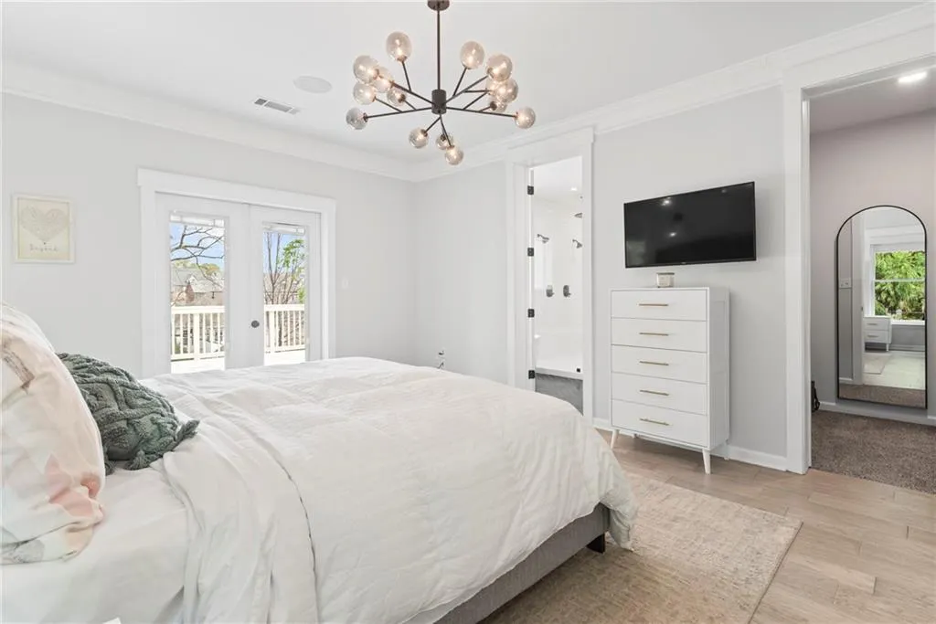 Primary bedroom has two walk in closets and a private balcony overlooking the rear yard.