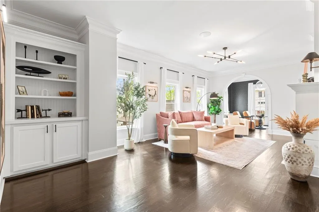 Custom built in cabinetry off the living room with a view into the home office/music room
