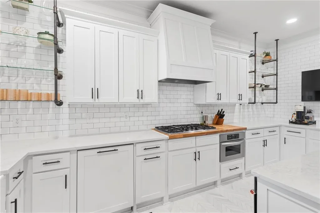Cabinetry covered dishwasher, rane hood and trash recepticle.