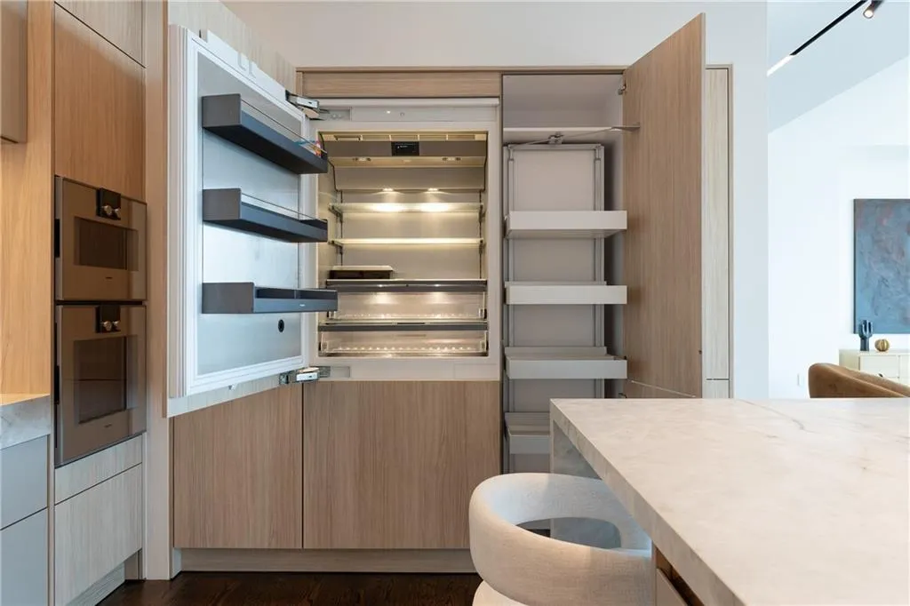 Large paneled refrigerator/freezer blends seamlessly into the design. Lots of storage in the pantry beside.