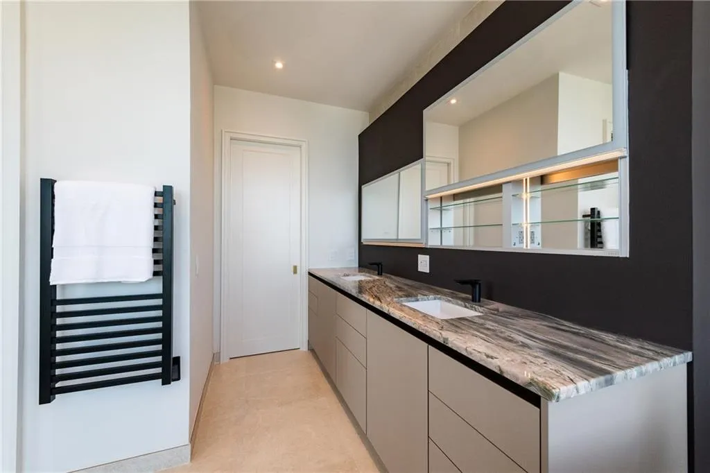 Lighted vanity mirrors slide up to reveal hidden storage.