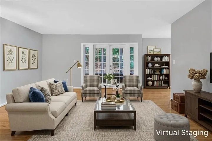 Hardwood flooring, painted walls, and white trim throughout