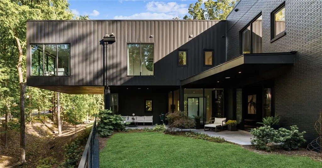 Back of house featuring a patio area and a lawn
