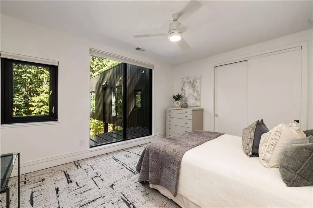 Bedroom featuring a closet, ceiling fan, and access to exterior