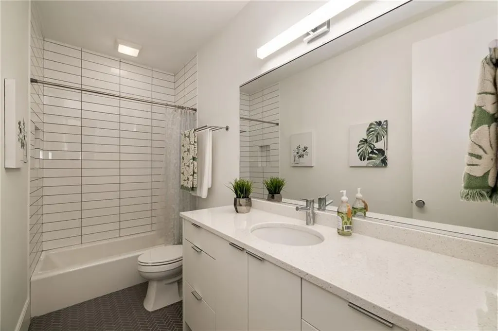 Full bathroom featuring vanity, shower / tub combo, toilet, and tile flooring
