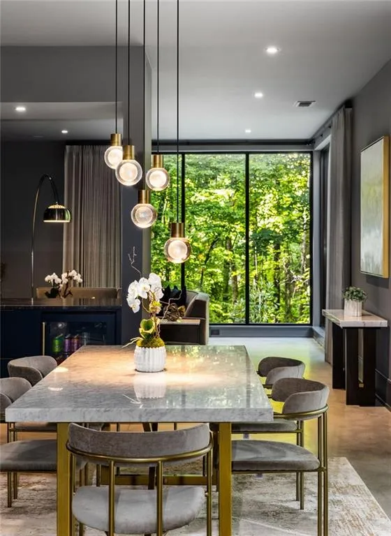 Dining area featuring concrete flooring, plenty of natural light, and expansive windows