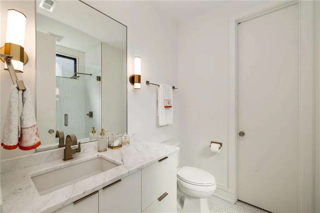 Bathroom with tile floors, toilet, and large vanity
