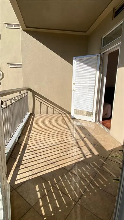 Balcony with tile flooring and a metal railing