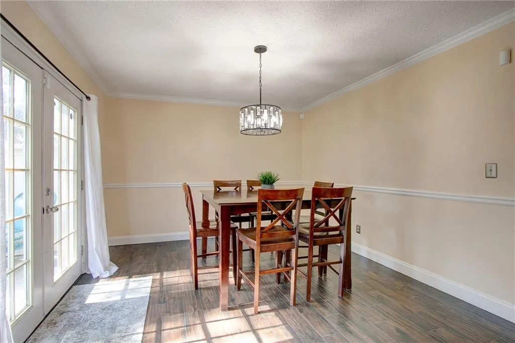 Dining area with lots of natural light, wood floors, and crown molding