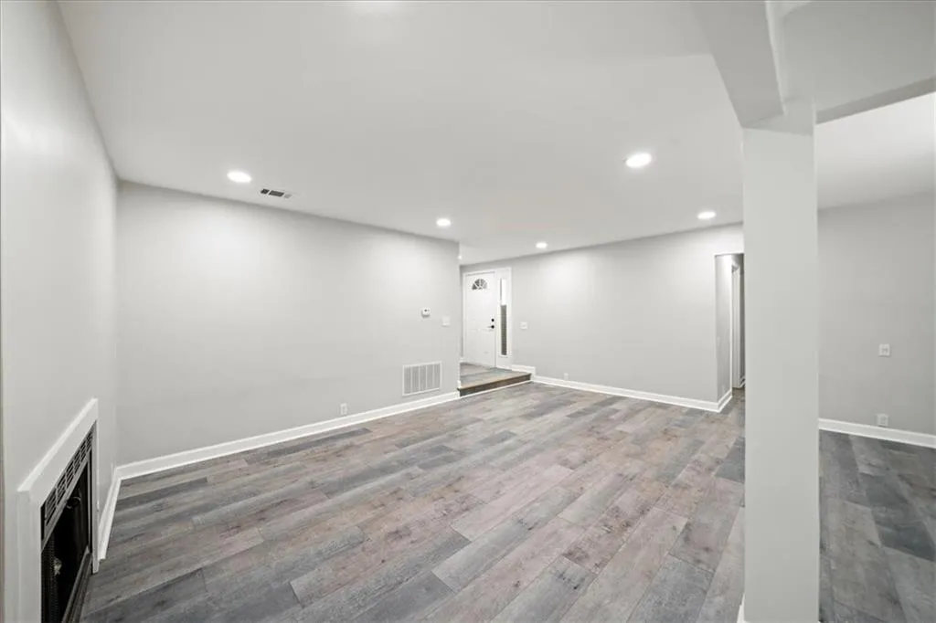 Below grade area with recessed lighting, wood finished floors, and baseboards