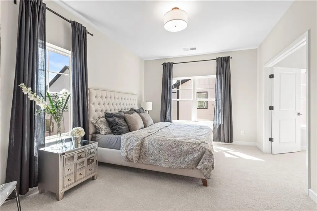 Bedroom featuring carpet flooring and baseboards
