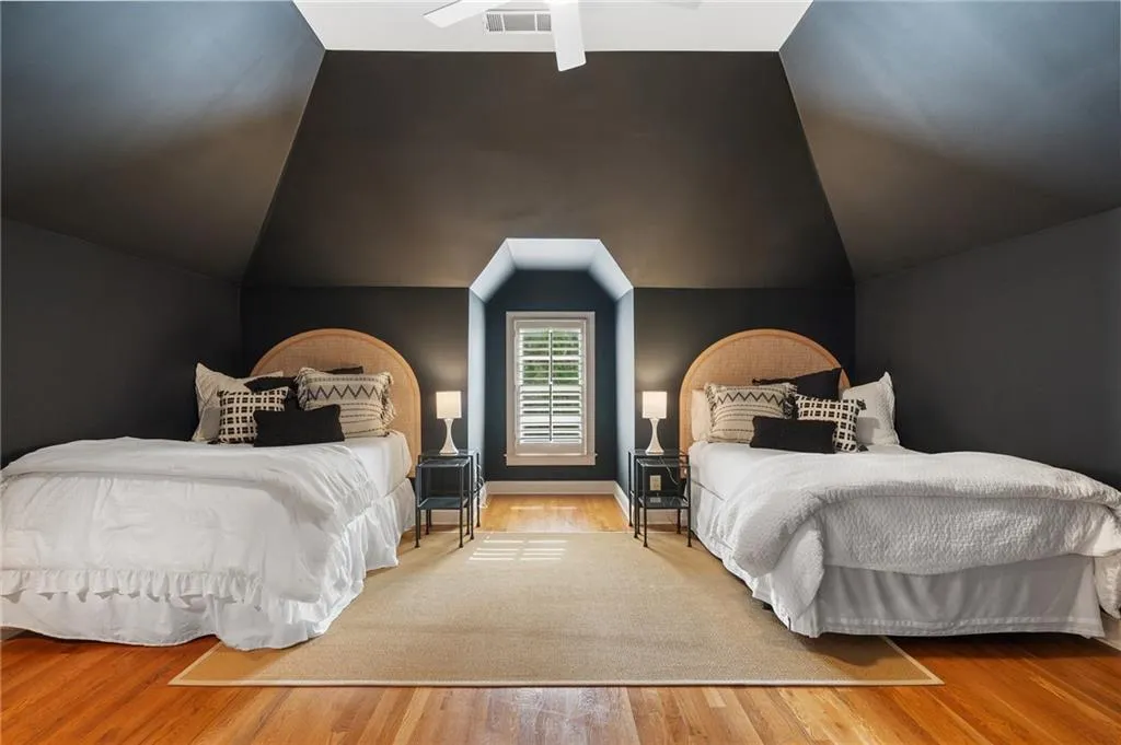 Bedroom with wood-type flooring and vaulted ceiling