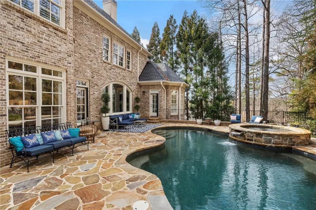 View of swimming pool with an in ground hot tub, pool water feature, an outdoor hangout area, and a patio area