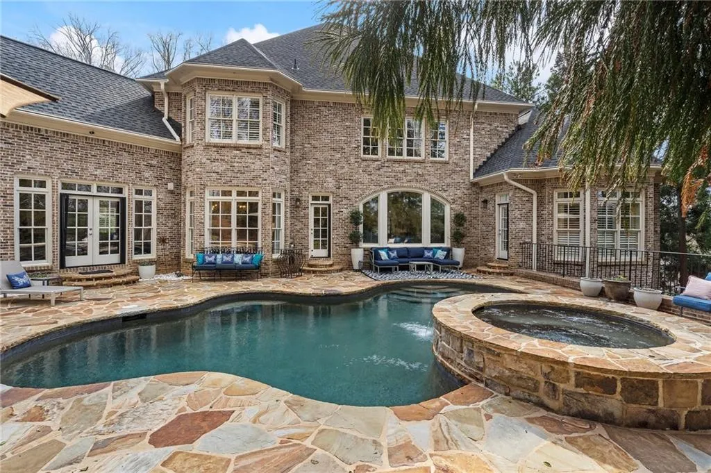 View of swimming pool featuring an in ground hot tub, outdoor lounge area, and a patio area