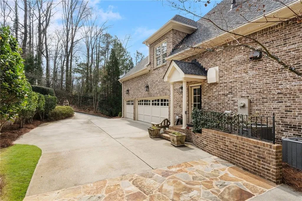 View of property exterior featuring a garage and central air condition unit