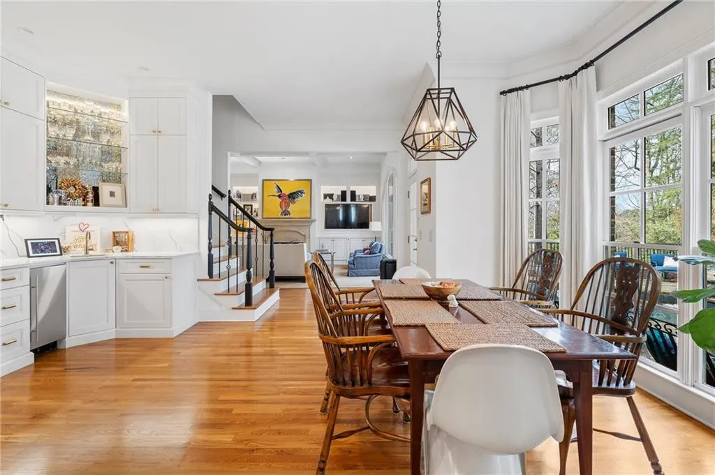 Dining room featuring light hardwood / wood-style flooring, ornamental molding, a chandelier, and a healthy amount of sunlight