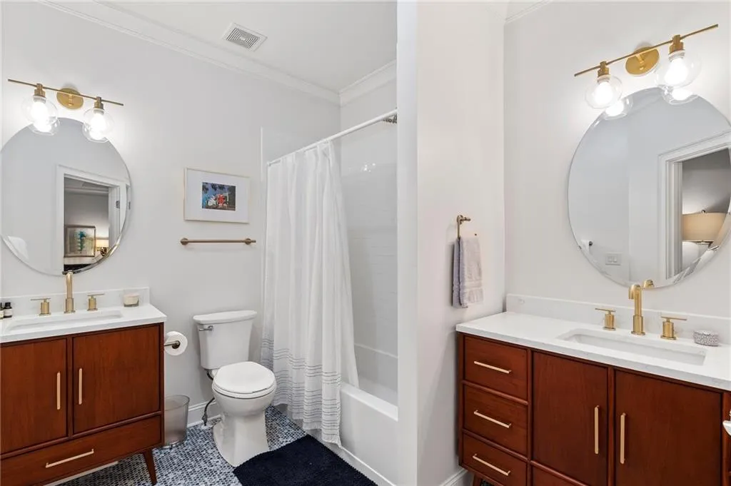 Full bathroom with toilet, crown molding, shower / tub combo, vanity, and tile patterned flooring