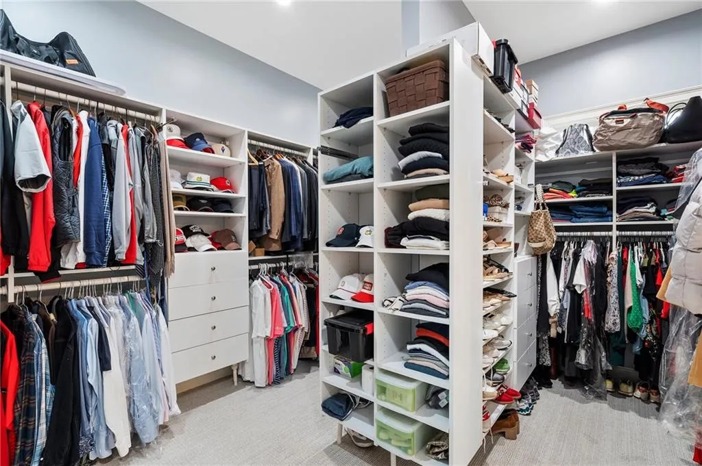 Walk in closet with light carpet