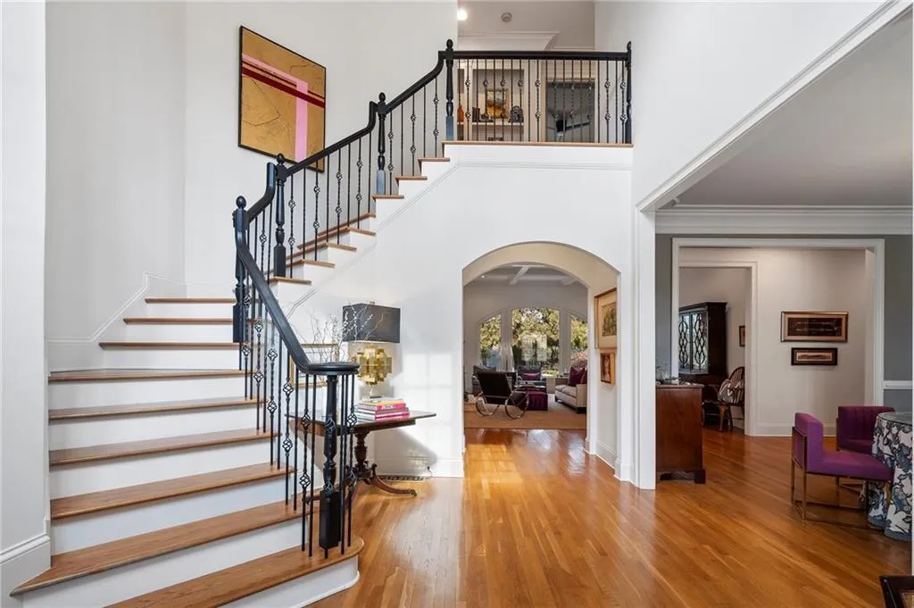 Entrance foyer featuring hardwood / wood-style flooring, crown molding, and a high ceiling