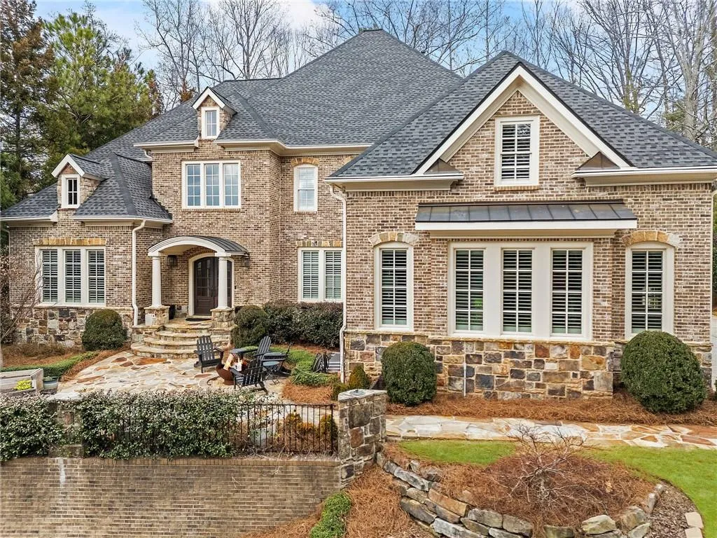 View of front of house featuring a patio and an outdoor fire pit