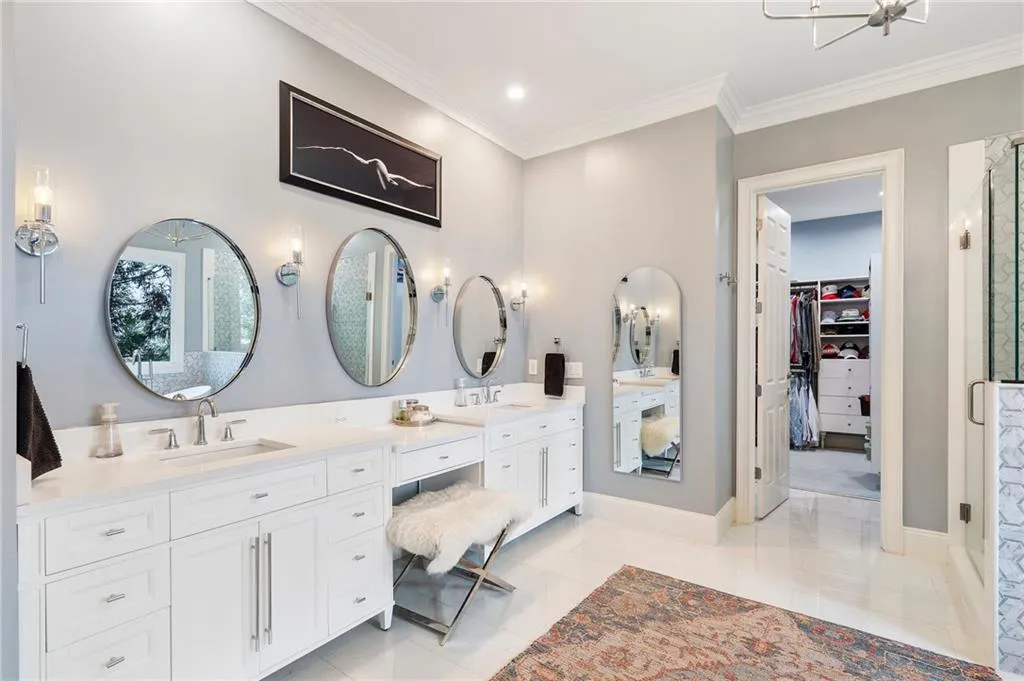 Bathroom featuring vanity, a shower with door, ornamental molding, and tile patterned floors