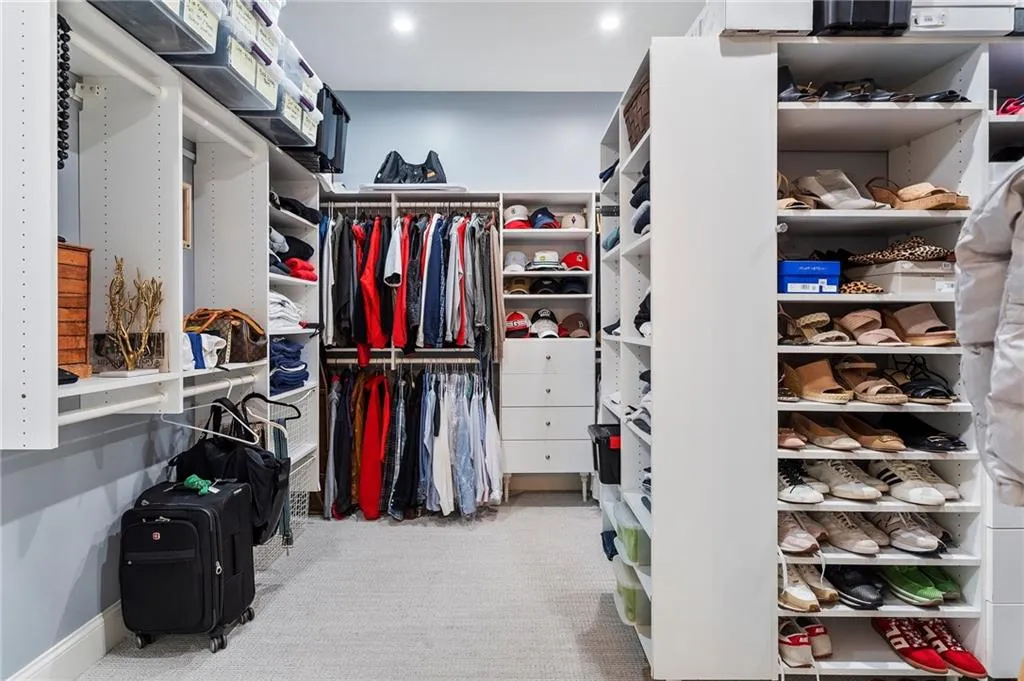 Walk in closet with light carpet