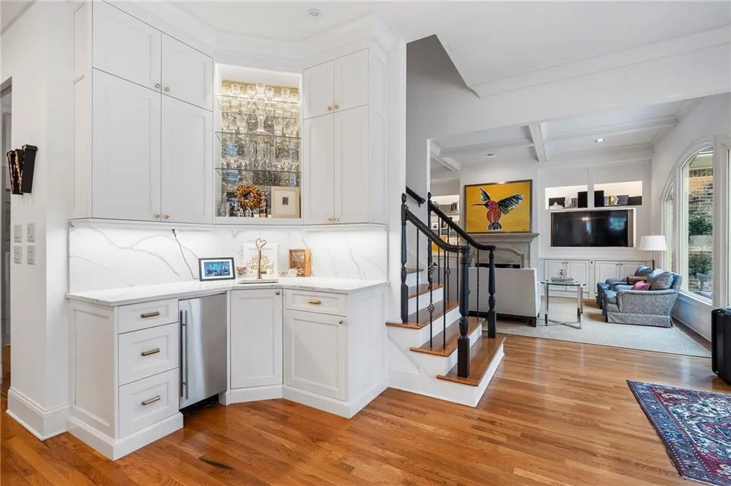 Bar with coffered ceiling, fridge, light hardwood / wood-style floors, and white cabinets