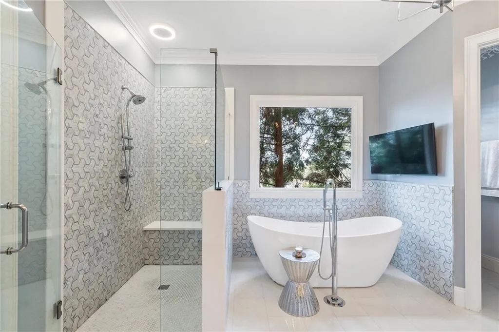 Bathroom featuring crown molding, independent shower and bath, tile patterned flooring, and tile walls
