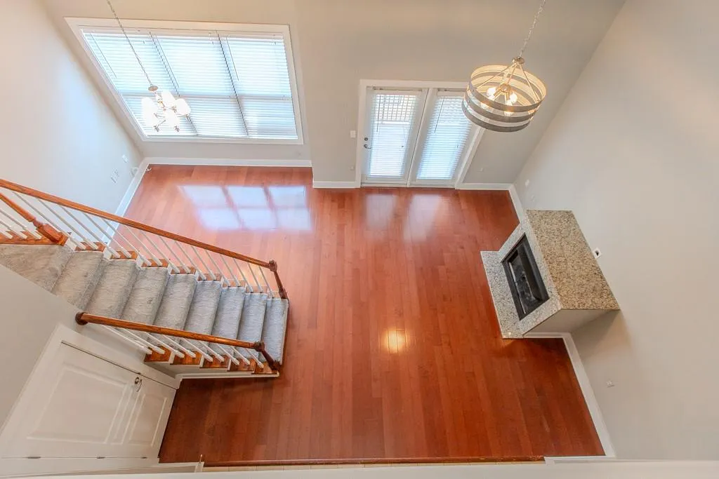 Entryway with a fireplace and hardwood / wood-style floors Entryway with a fireplace and hardwood / wood-style floors