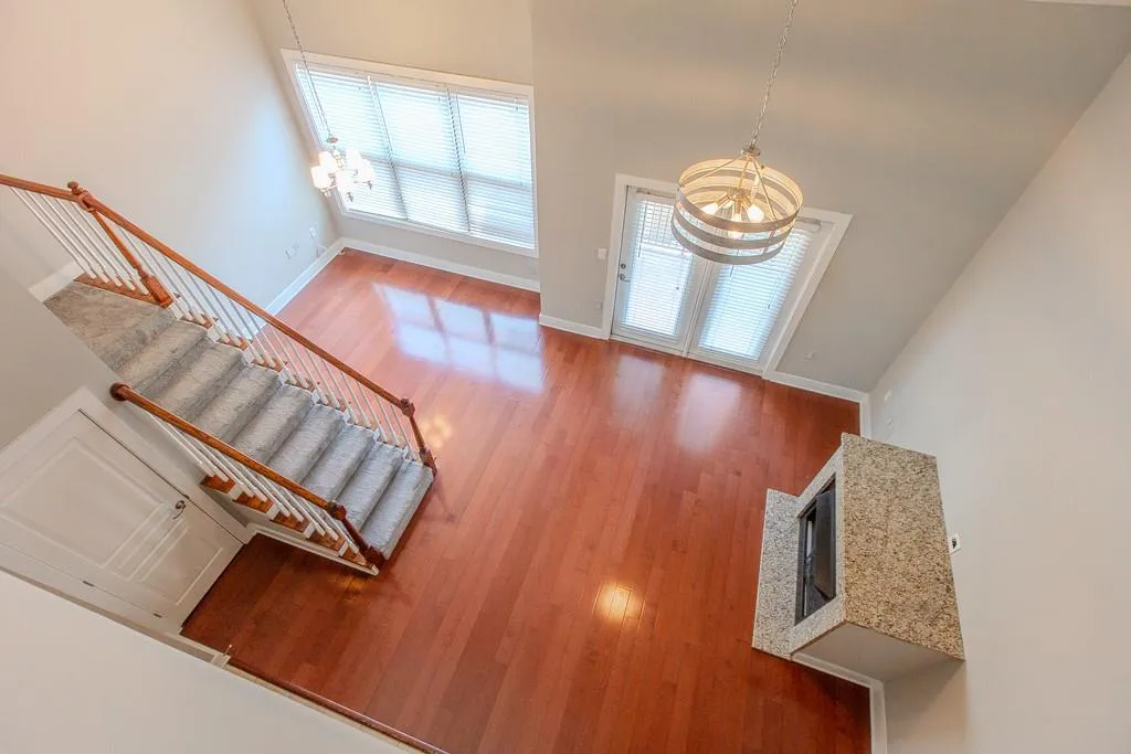 Entrance foyer with a notable chandelier, hardwood / wood-style flooring, and a towering ceiling Entrance foyer with a notable chandelier, hardwood / wood-style flooring, and a towering ceiling