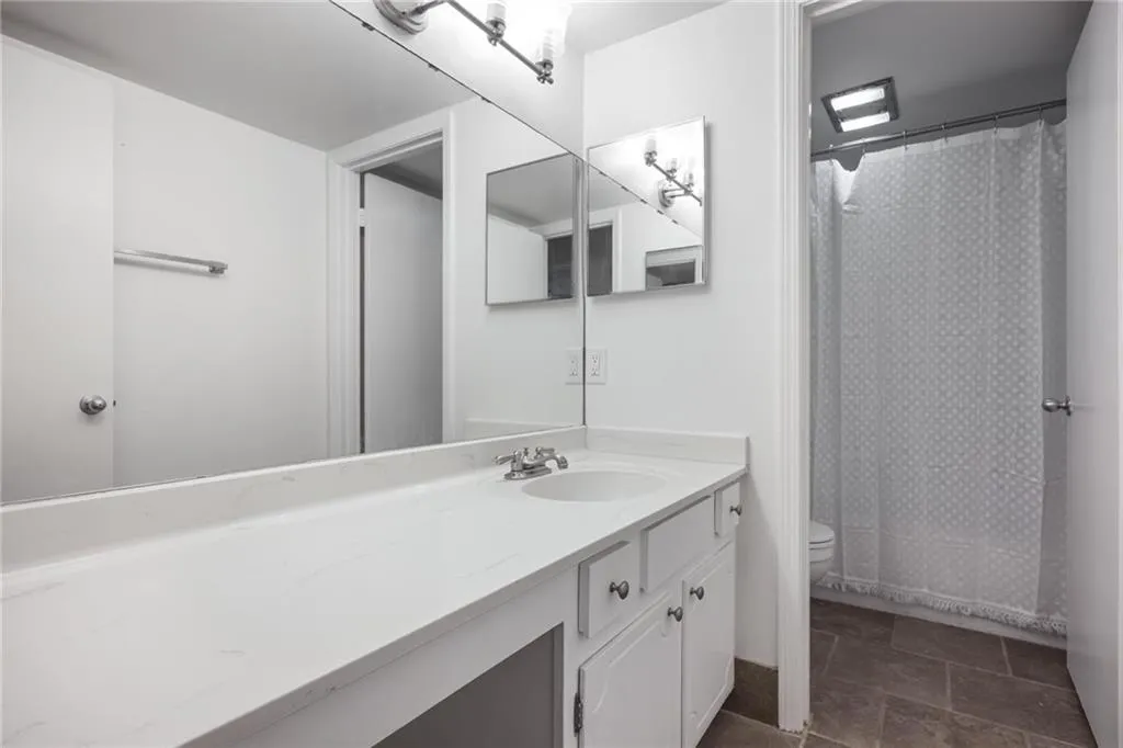 Expansive vanity with integrated sink and chrome faucet