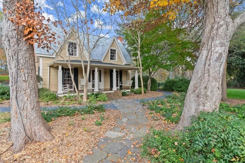 Mature rare trees create a beautiful shade garden surrounding front porch