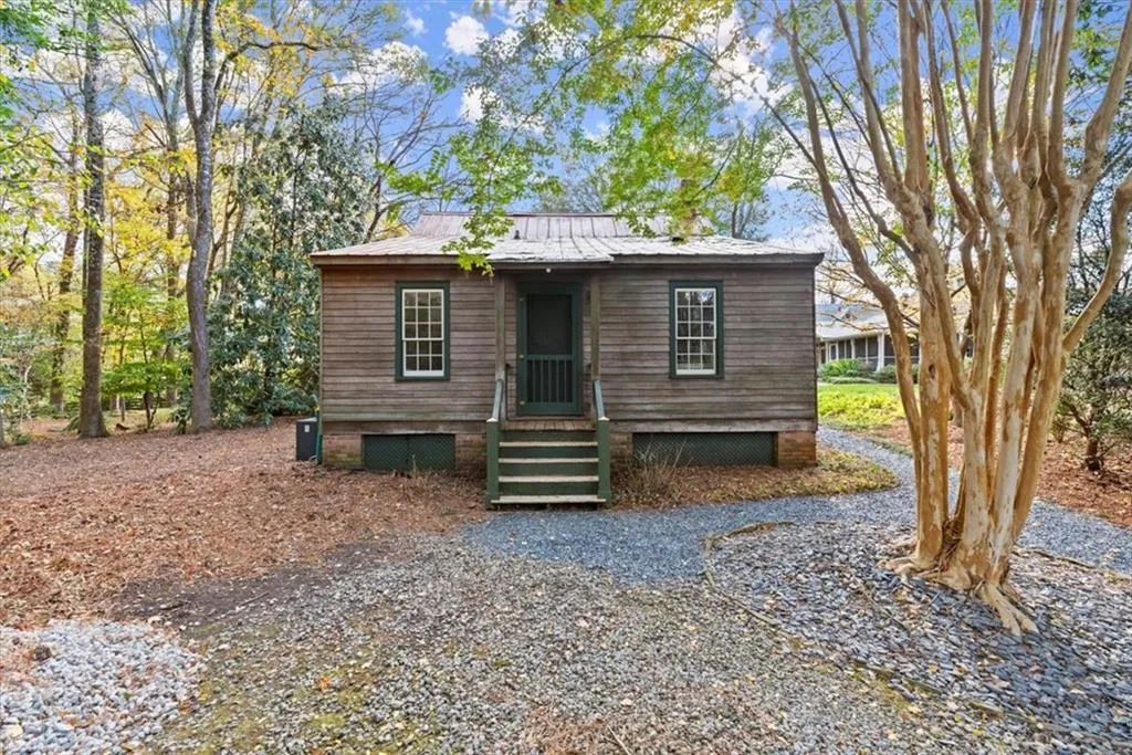 Back of guest house with parking for guests