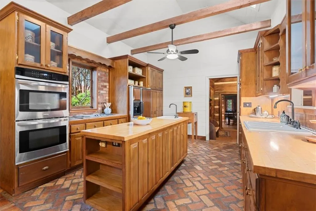 Kitchen features vaulted ceiling and skylights