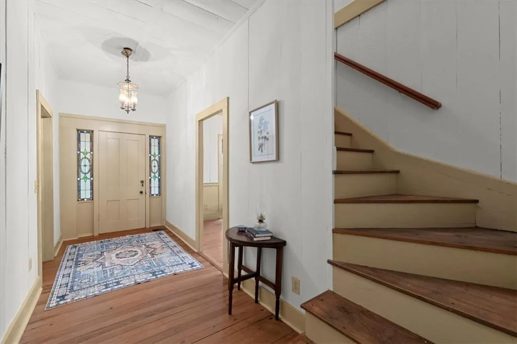 Spacious entry foyer. Upstairs are 2 precious bedrooms, a full bath and storage