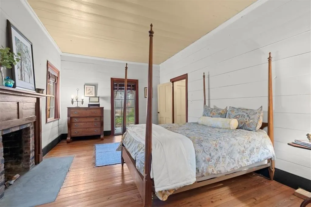 Front bedroom in front of home with fireplace and large en suite bath
