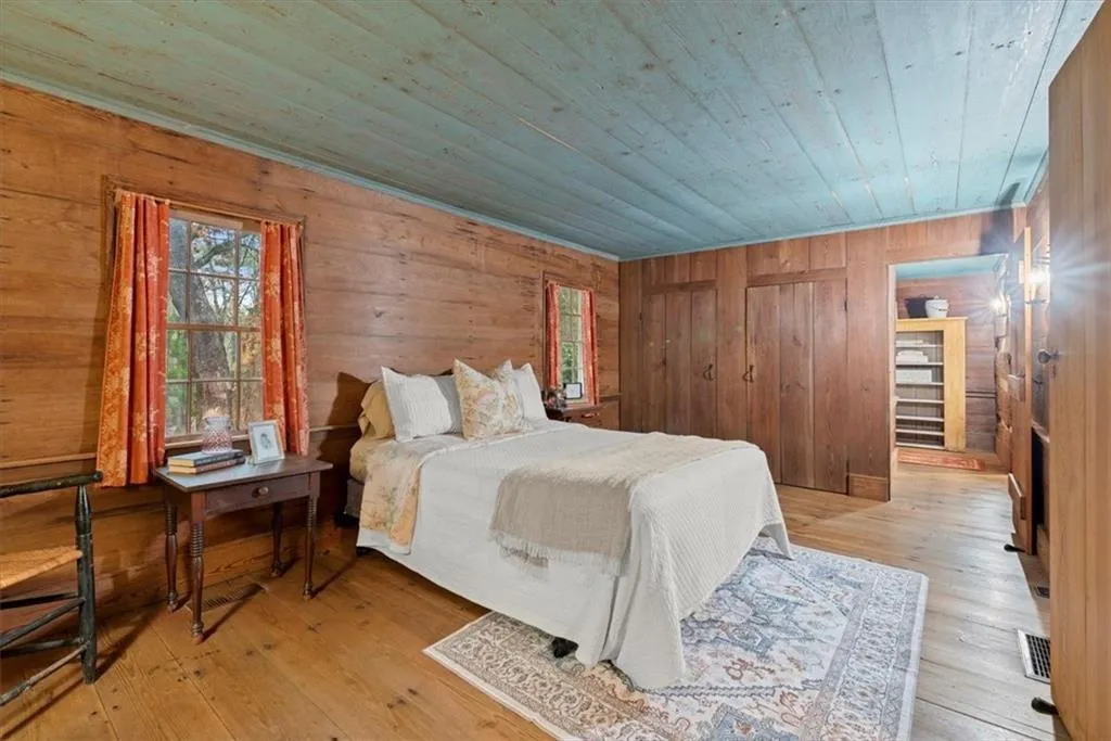 Main level bedroom at the back of the log cabin