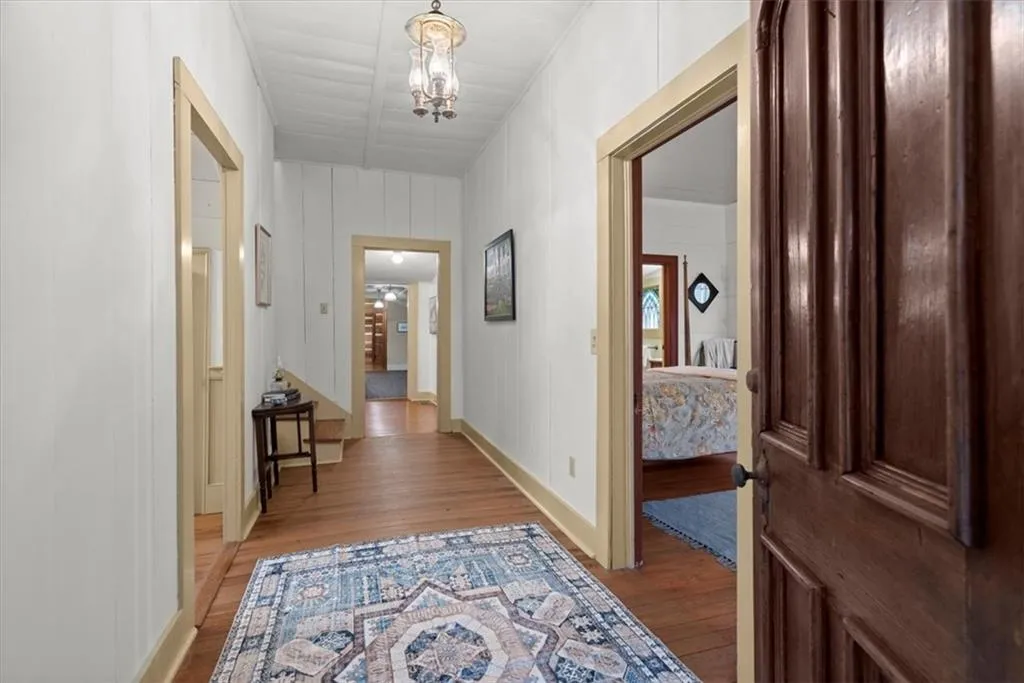 Original hardwood floors throughout. Wide wood plank walls. Parlor is on the left, Front bedroom on the right and upstairs to 2 bedrooms, 1 full bath