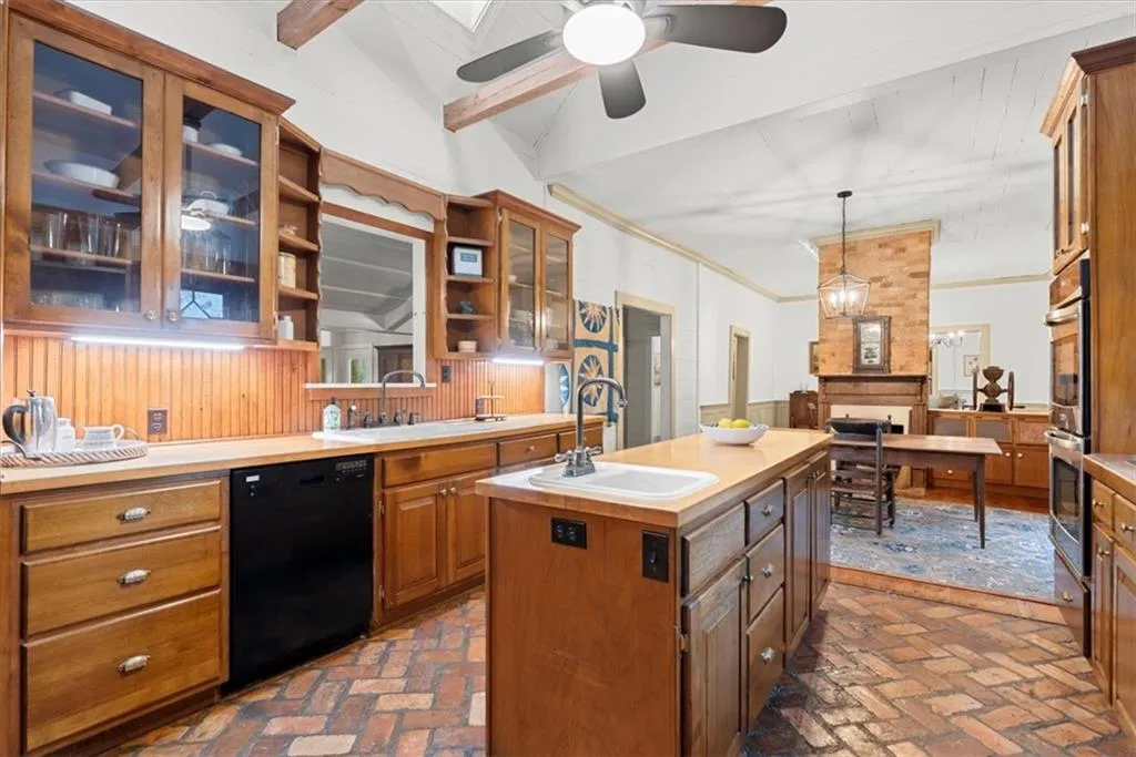 Kitchen with charming brick floors and glass front cabinets