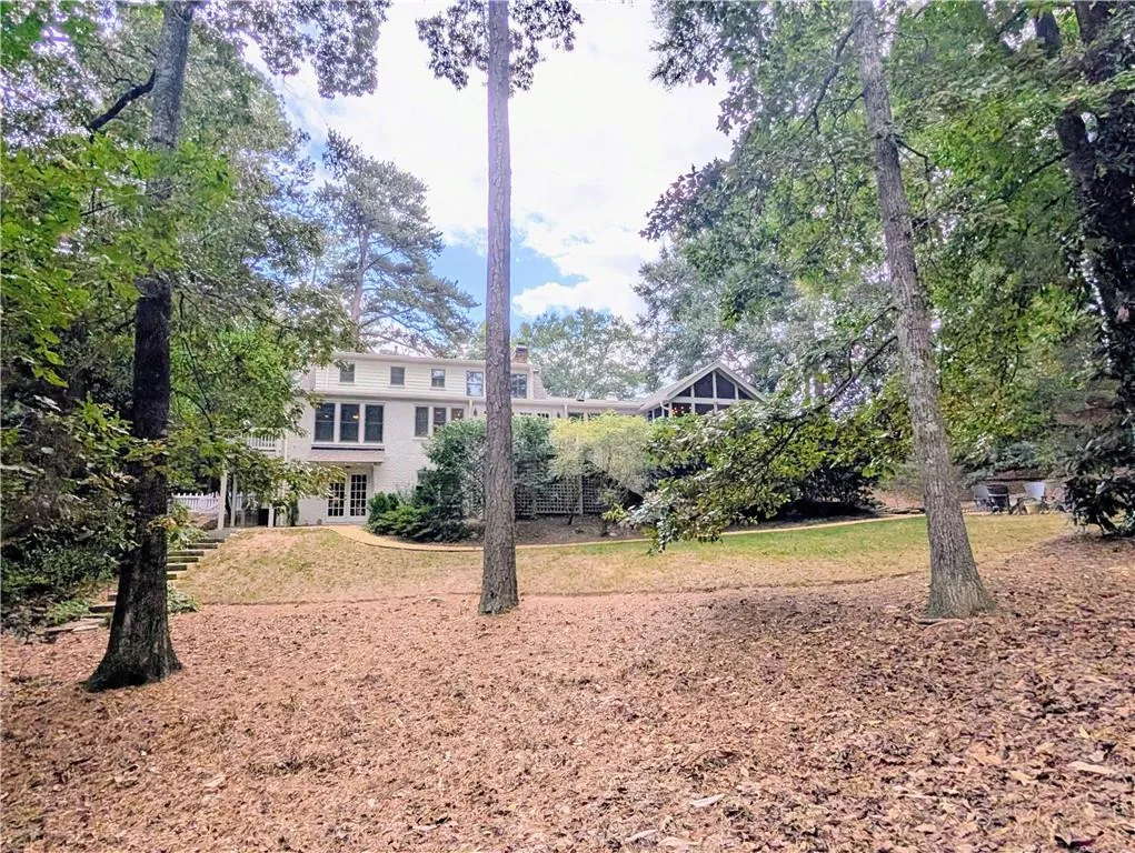 Back of home showing all 3 stories, and the incredibly private 1.2+/- acre lot!