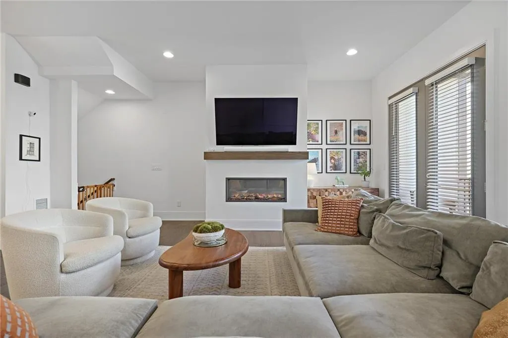 The light-filled living room offers a cozy ventless fireplace and additional flex space ideal for a breakfast room, reading nook, bar cart, or play area.