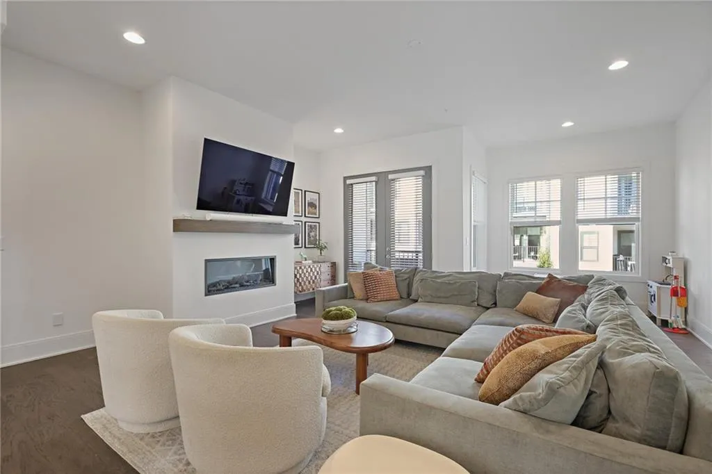 The light-filled living room offers a cozy ventless fireplace and additional flex space ideal for a breakfast room, reading nook, bar cart, or play area.