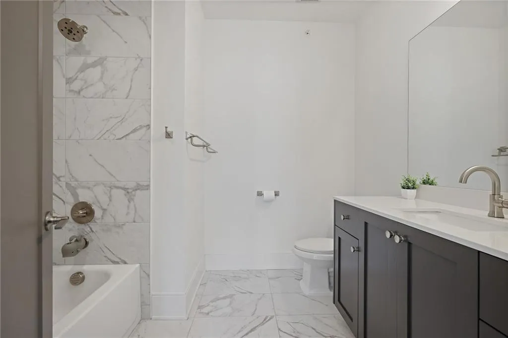 The adjacent guest bedroom includes an oversized walk-in closet and en-suite bath.