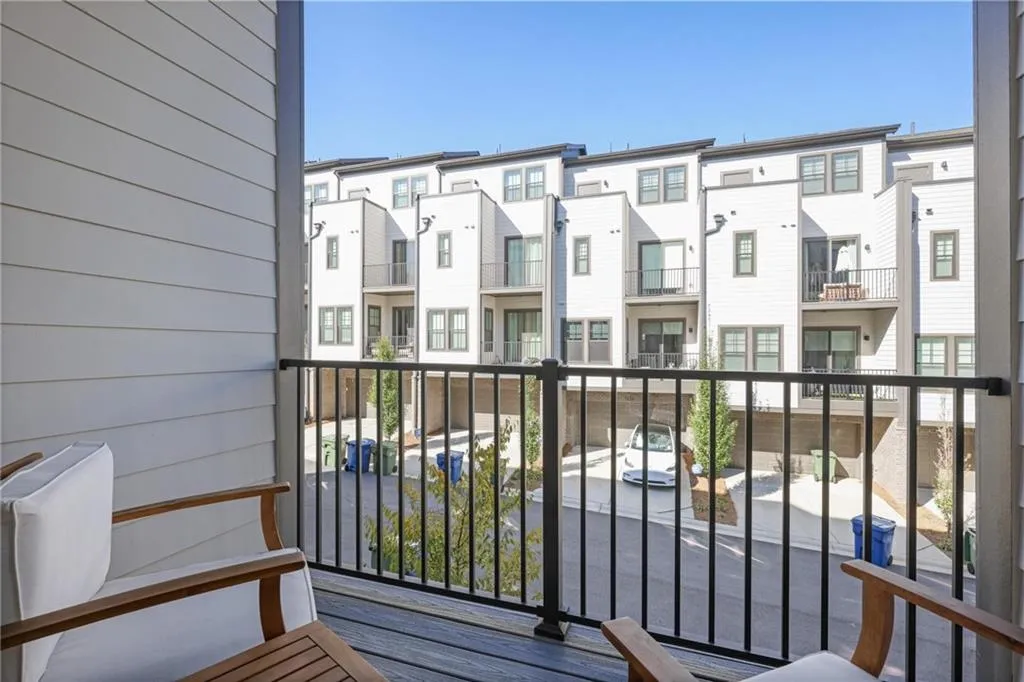 Private covered balconies are located off the living room and primary bedroom.