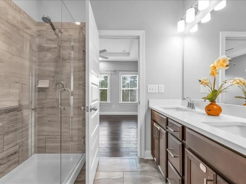 Bathroom with a shower stall and double vanity