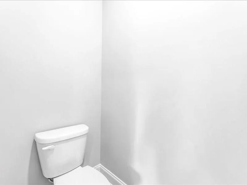 Bathroom featuring toilet and baseboards