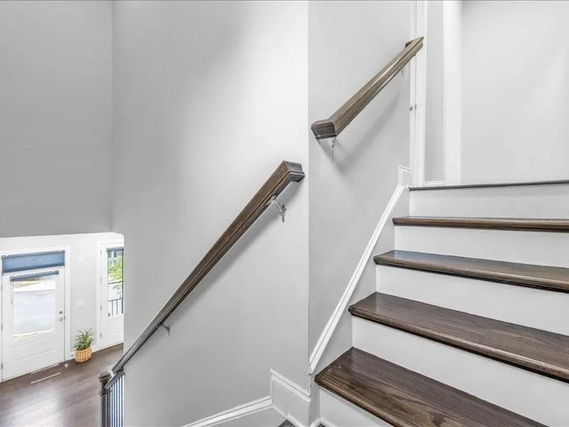 Stairs featuring wood finished floors and baseboards