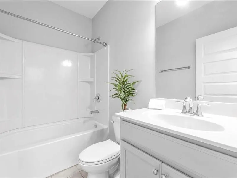 Full bath featuring vanity, tub / shower combination, and tile patterned flooring