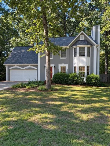 Two-story residence with a gray exterior and white trim