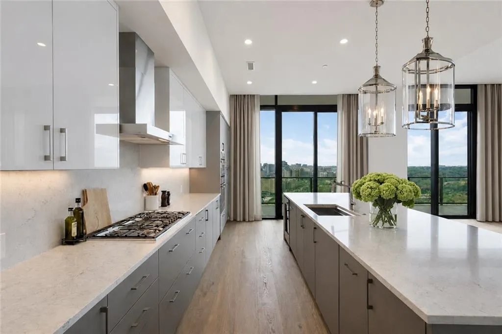 Gourmet Kitchen with large center island, gas cooking, double ovens, wine storage, beverage cooler and commercial size Refrigerator/Freezer.